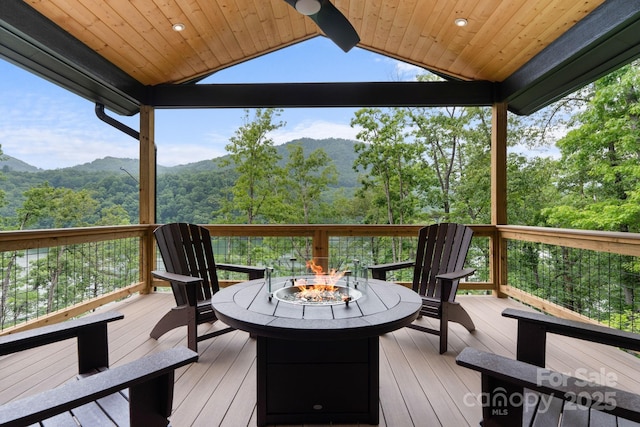 192 Lakeview Trl, Bryson City, NC 28713 - wooden deck with an outdoor fire pit, a mountain view, and a view of trees