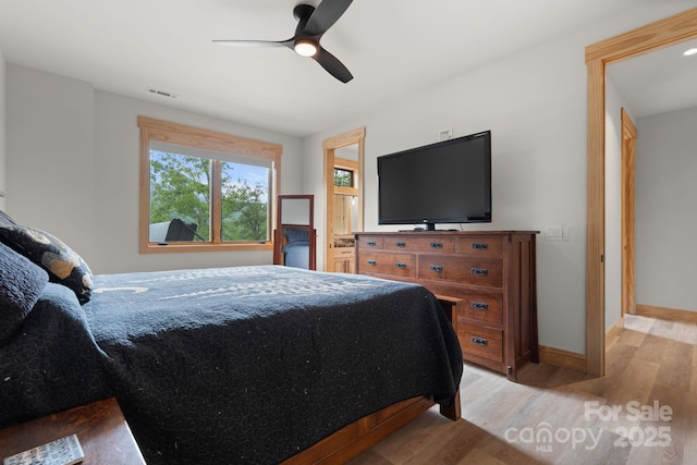192 Lakeview Trl, Bryson City, NC 28713 - bedroom with light wood-style floors, baseboards, and a ceiling fan