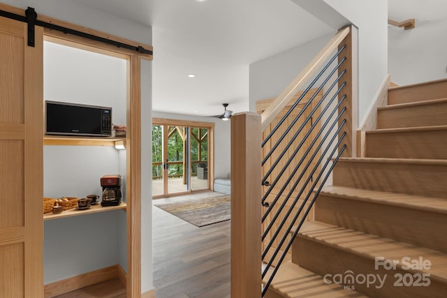192 Lakeview Trl, Bryson City, NC 28713 - staircase with wood finished floors, recessed lighting, a barn door, and a ceiling fan