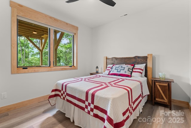 192 Lakeview Trl, Bryson City, NC 28713 - bedroom with baseboards, wood finished floors, and ceiling fan