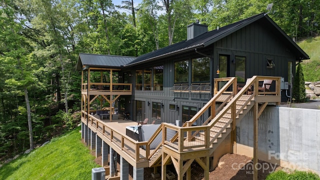 192 Lakeview Trl, Bryson City, NC 28713 - rear view of property with board and batten siding, a deck, and a chimney