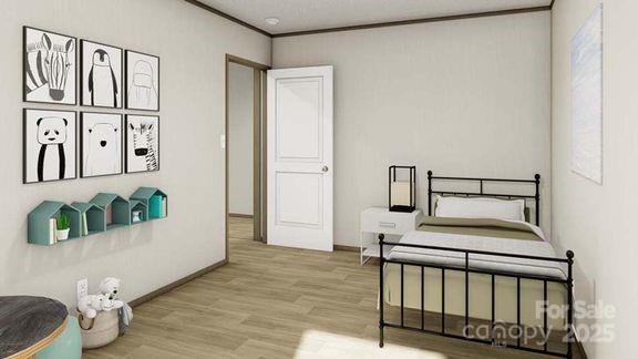 bedroom with wood finished floors, baseboards, and ornamental molding