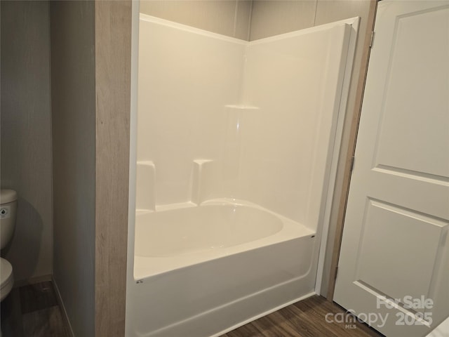 full bath with toilet, a tub, wood finished floors, and a shower