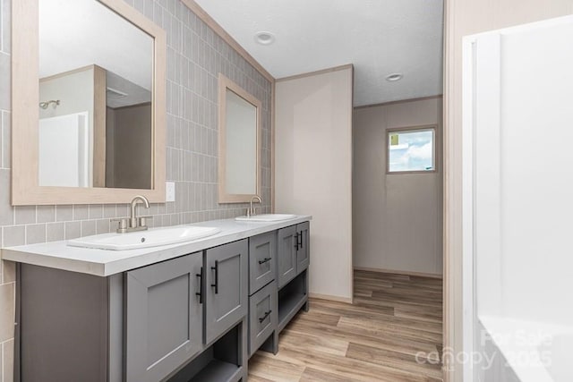 28 Mcgee Hill Rd, Fairview, NC 28730 - full bath with double vanity, wood finished floors, decorative backsplash, and tile walls