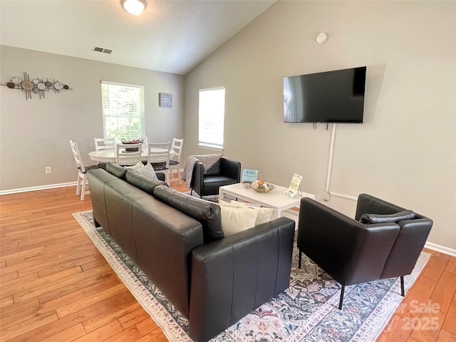 218 Cottonwood Park Dr, Charlotte, NC 28214 - living area featuring light wood finished floors, visible vents, baseboards, and vaulted ceiling