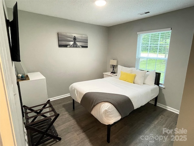 218 Cottonwood Park Dr, Charlotte, NC 28214 - bedroom featuring a textured ceiling, dark wood-style floors, visible vents, and baseboards