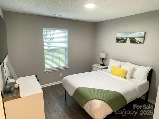 218 Cottonwood Park Dr, Charlotte, NC 28214 - bedroom with baseboards, a textured ceiling, and dark wood-style flooring