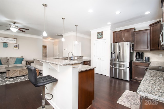128 Millen Dr, Mooresville, NC 28115 - kitchen featuring stainless steel fridge with ice dispenser, a ceiling fan, dark wood finished floors, ornamental molding, and a kitchen breakfast bar
