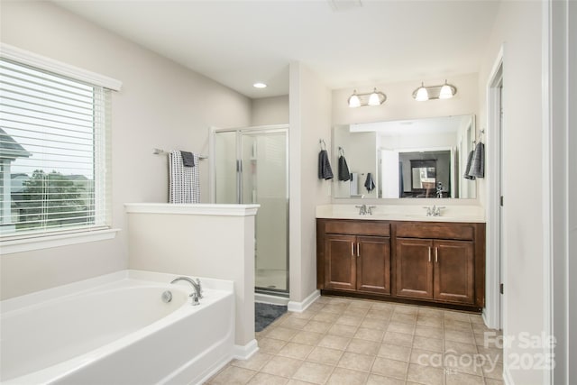 128 Millen Dr, Mooresville, NC 28115 - bathroom featuring a shower stall, a garden tub, double vanity, and plenty of natural light