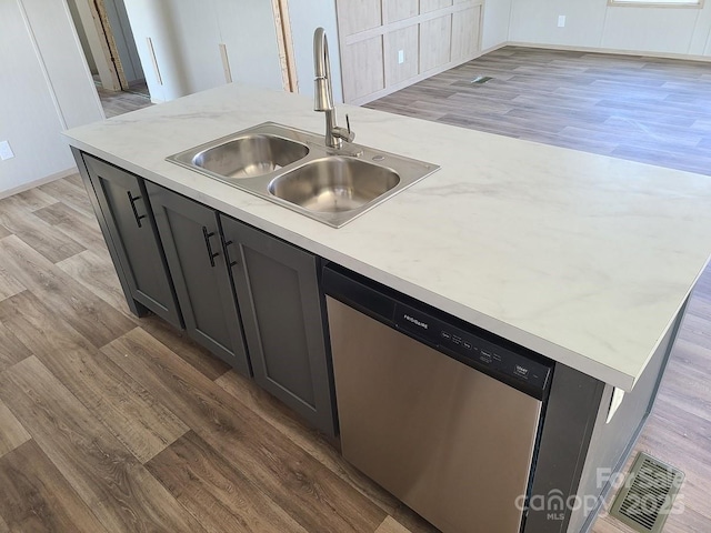22 Mcgee Hill Rd, Fairview, NC 28730 - kitchen featuring stainless steel dishwasher, light wood-style flooring, and an island with sink