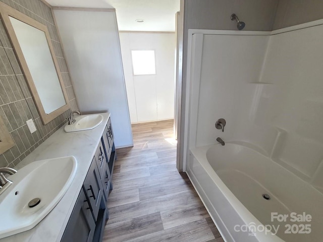 22 Mcgee Hill Rd, Fairview, NC 28730 - full bath featuring backsplash, double vanity, wood finished floors, and shower / washtub combination