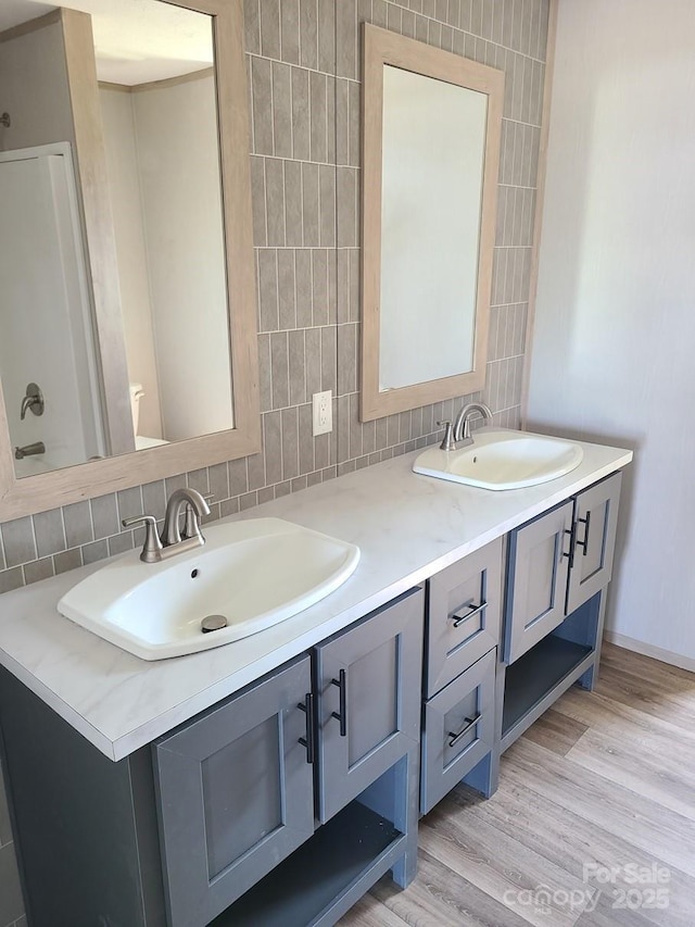 22 Mcgee Hill Rd, Fairview, NC 28730 - full bathroom featuring double vanity, decorative backsplash, and wood finished floors