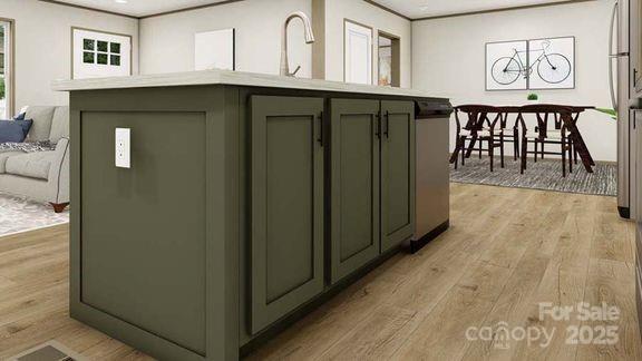 22 Mcgee Hill Rd, Fairview, NC 28730 - kitchen with light wood finished floors, open floor plan, light countertops, green cabinetry, and a kitchen island with sink