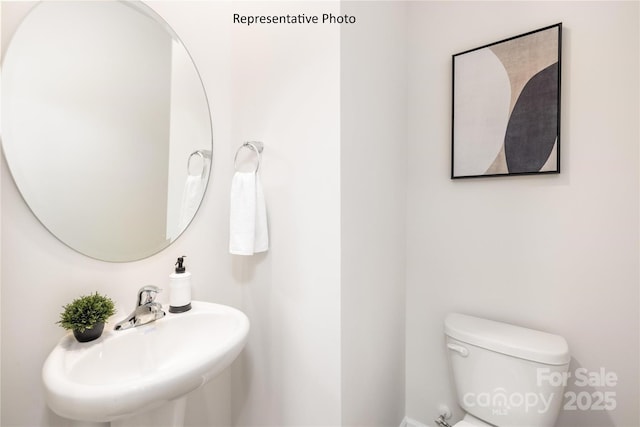 half bath with toilet and a sink
