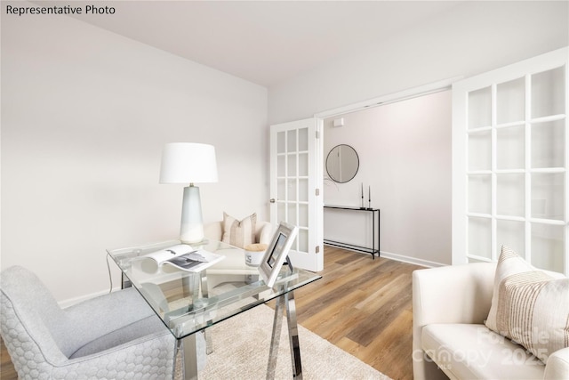 office area with baseboards, french doors, and wood finished floors