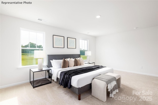bedroom featuring carpet floors, visible vents, and baseboards