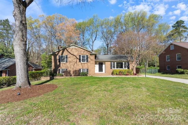 3808 Severn Ave, Charlotte, NC 28210 - split level home featuring a front lawn, a chimney, and concrete driveway