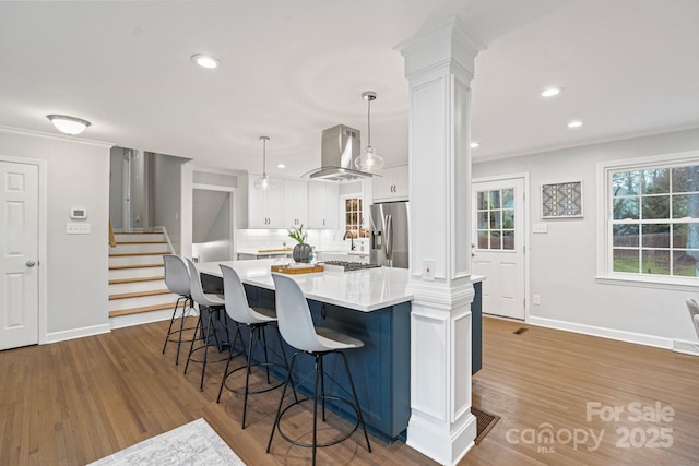 3808 Severn Ave, Charlotte, NC 28210 - kitchen with decorative columns, white cabinets, stainless steel fridge, and extractor fan