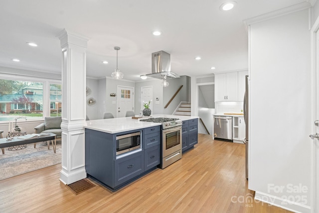 3808 Severn Ave, Charlotte, NC 28210 - kitchen featuring light wood-style flooring, decorative columns, appliances with stainless steel finishes, white cabinetry, and extractor fan