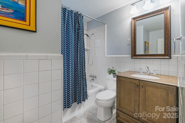 3808 Severn Ave, Charlotte, NC 28210 - full bathroom with a wainscoted wall, toilet, vanity, shower / tub combo, and tile walls