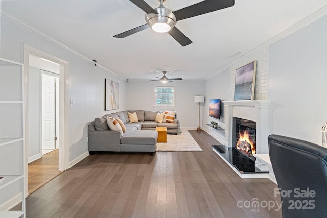 3808 Severn Ave, Charlotte, NC 28210 - living area with a warm lit fireplace, ceiling fan, and dark wood-style flooring