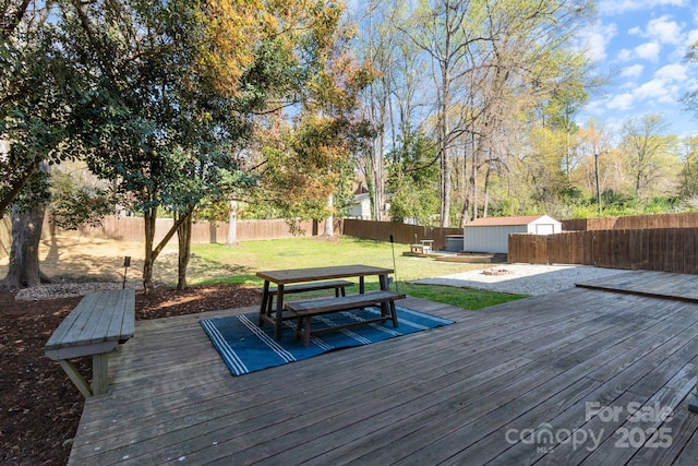 3808 Severn Ave, Charlotte, NC 28210 - wooden deck with an outdoor structure, a fenced backyard, a storage unit, outdoor dining area, and a yard