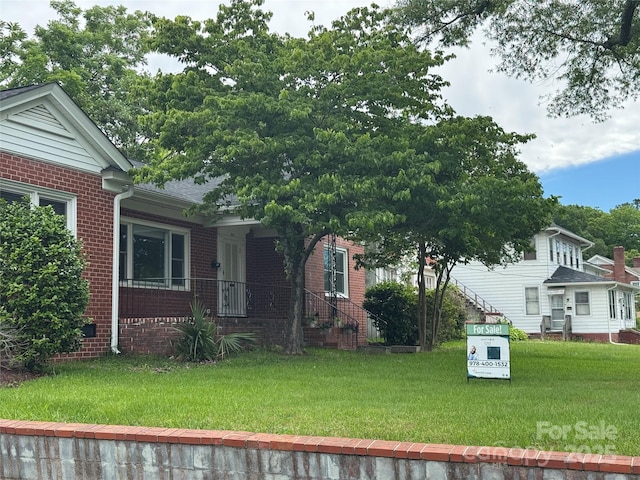 603 E Main St, Rock Hill, SC 29730 - view of front of house with brick siding, a front lawn, and a porch