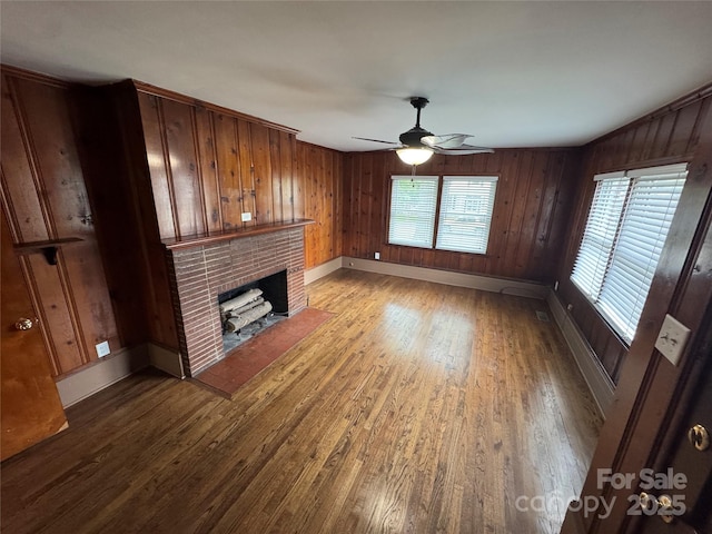 603 E Main St, Rock Hill, SC 29730 - unfurnished living room featuring a brick fireplace, wood finished floors, ceiling fan, and wood walls