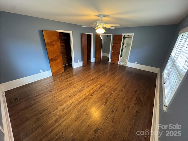 603 E Main St, Rock Hill, SC 29730 - unfurnished bedroom with wood finished floors, ceiling fan, and multiple closets