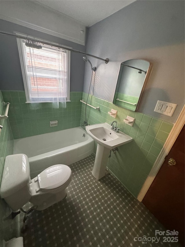 603 E Main St, Rock Hill, SC 29730 - bathroom with tile walls, shower / washtub combination, a wainscoted wall, and tile patterned flooring