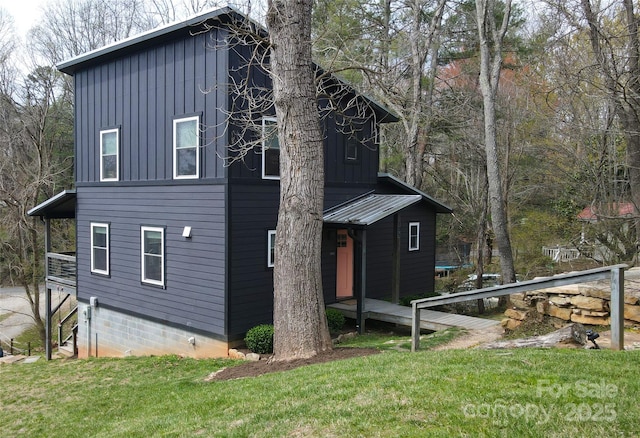 view of property exterior with a yard and board and batten siding