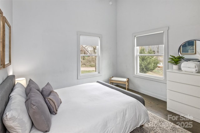 bedroom featuring baseboards and wood finished floors