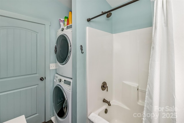 clothes washing area with stacked washing maching and dryer and laundry area