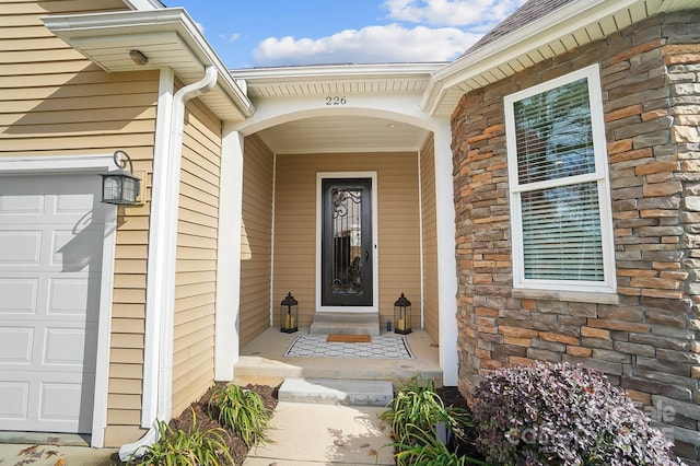 226 Hermance Ln, Mooresville, NC 28117 - property entrance featuring stone siding and an attached garage