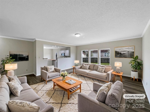 living room featuring crown molding, wood finished floors, baseboards, and a textured ceiling