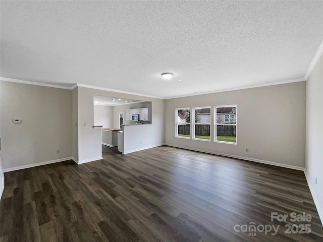 unfurnished living room with baseboards, a textured ceiling, and dark wood-style flooring