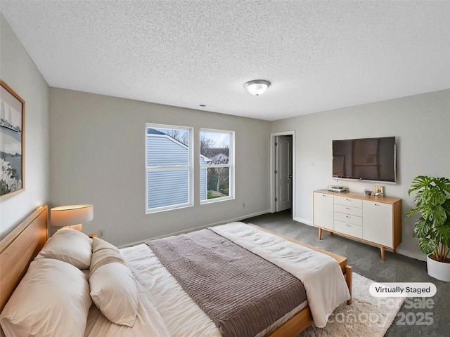 bedroom featuring carpet flooring, a textured ceiling, and baseboards