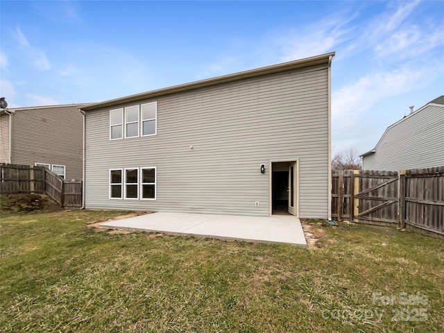 back of house with a yard, a fenced backyard, and a patio area