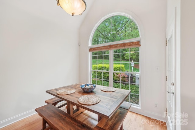 dining space with light wood-style flooring and baseboards