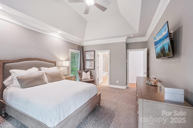 carpeted bedroom with baseboards, vaulted ceiling, ornamental molding, connected bathroom, and ceiling fan
