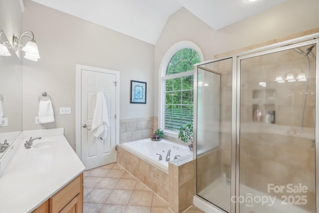 bathroom with tile patterned floors, vanity, a garden tub, and a stall shower