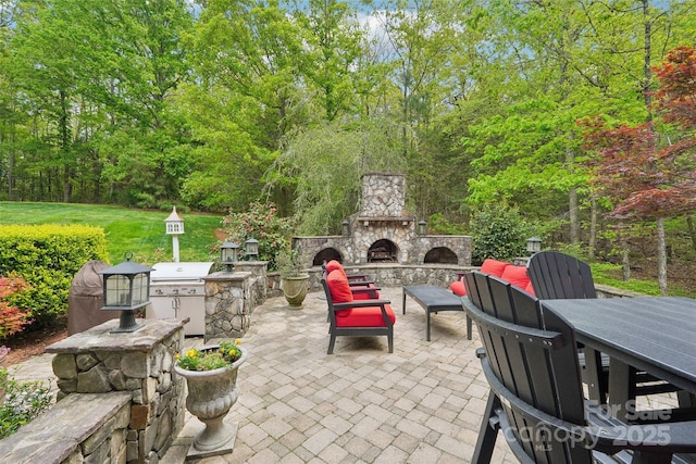 view of patio featuring an outdoor stone fireplace