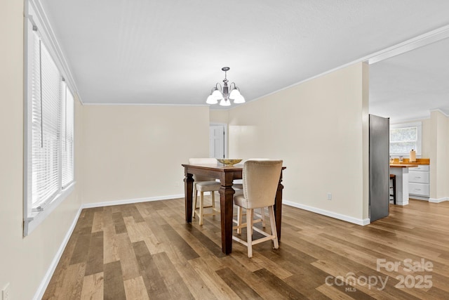 117 Pine Bluff Dr, Mooresville, NC 28117 - dining space with a chandelier, ornamental molding, baseboards, and wood finished floors