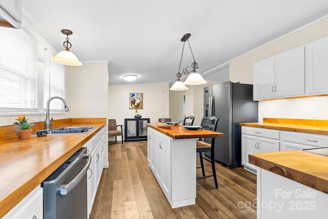 117 Pine Bluff Dr, Mooresville, NC 28117 - kitchen with a sink, stainless steel appliances, butcher block countertops, and white cabinets