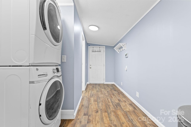 117 Pine Bluff Dr, Mooresville, NC 28117 - clothes washing area with crown molding, baseboards, laundry area, stacked washing maching and dryer, and wood finished floors