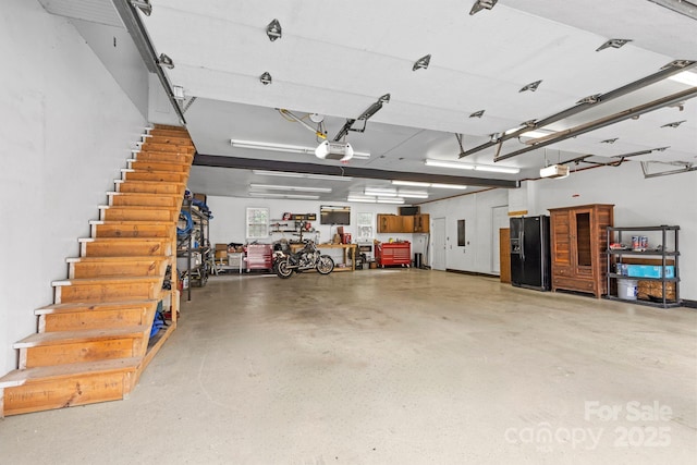 117 Pine Bluff Dr, Mooresville, NC 28117 - garage with black fridge and a garage door opener