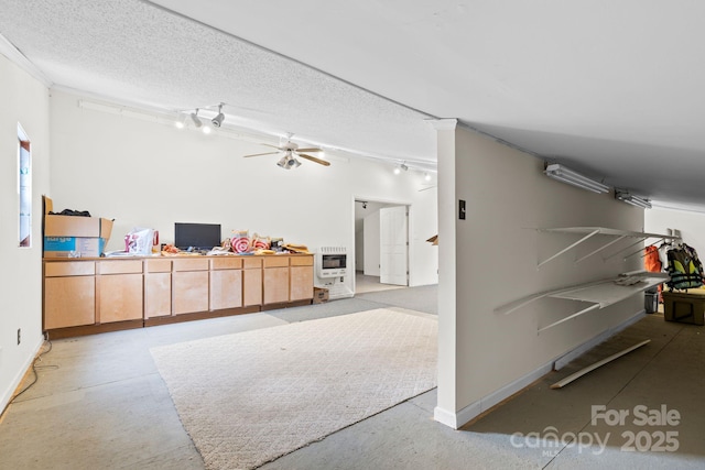 117 Pine Bluff Dr, Mooresville, NC 28117 - interior space featuring baseboards, ceiling fan, rail lighting, heating unit, and a textured ceiling