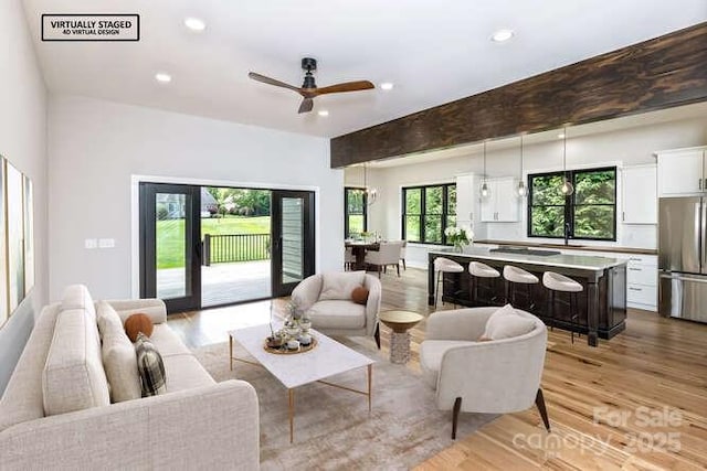 living area with recessed lighting, ceiling fan, and light wood-type flooring