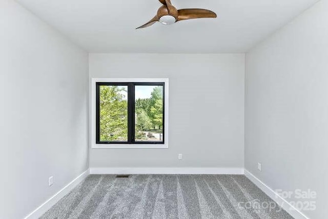 unfurnished room with carpet floors, baseboards, and ceiling fan