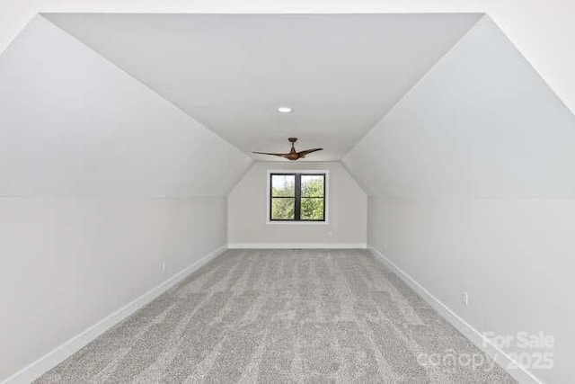 additional living space featuring baseboards, carpet flooring, and lofted ceiling